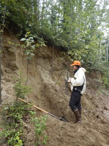 Student observes the stratigraphy of a landslide deposit