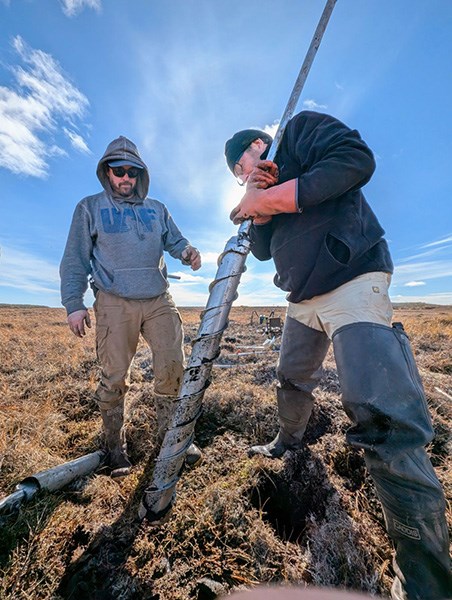 Mikhail Kanevskiy and Benjamin Jones core ice-rich permafrost in Bethel, Alaska.