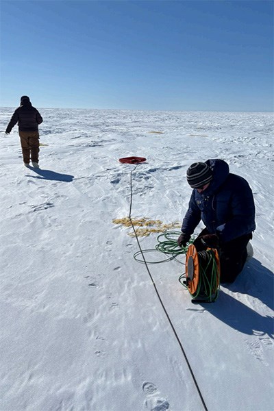 The Thaw Below Zero team takes transient electromagnetics (TEM) measurements at a shallow lake.