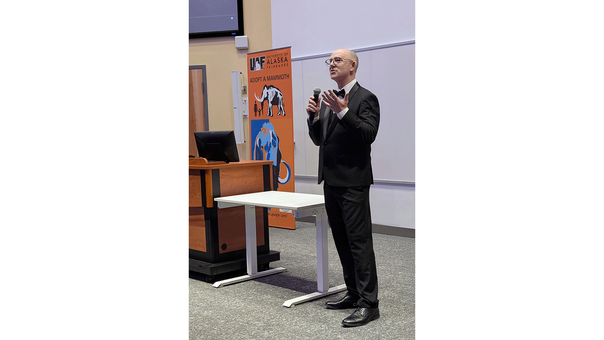 Matthew Wooller addresses the audience during the December 3, 2025 screening of Mammoth Hunters at the University of Alaska Fairbanks Schaible Auditorium.