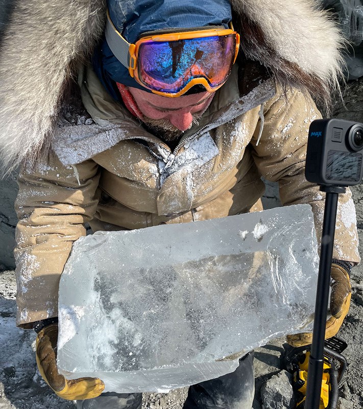 INE researcher Phillip Wilson holds a 45-kilogram sample of what is believed to be 350,000-year-old glacial ice. Photo by Benjamin Jones.