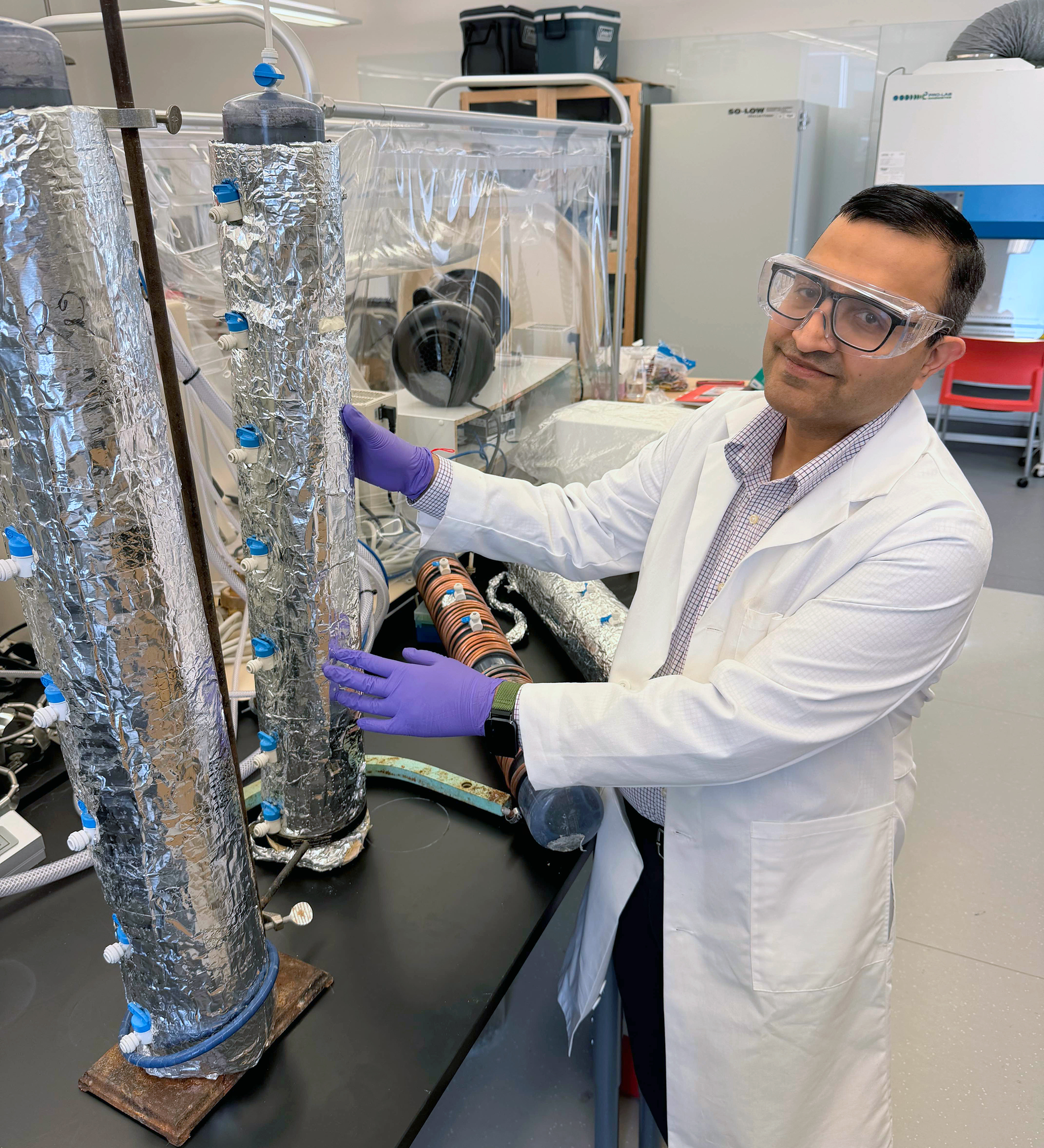 Srijan Aggarwal, UAF professor of environmental engineering, works with laboratory equipment used in his research on critical mineral recovery. Aggarwal is part of a $6 million National Science Foundation collaboration investigating how biological processes and artificial intelligence can improve the recovery of rare earth elements from waste materials. Photo by Kate Avery.
