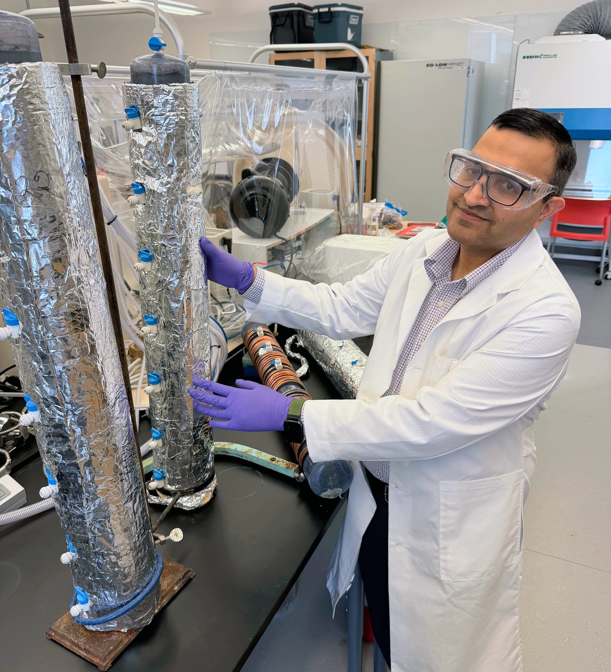 Srijan Aggarwal, UAF professor of environmental engineering, works with laboratory equipment used in his research on critical mineral recovery. Aggarwal is part of a $6 million National Science Foundation collaboration investigating how biological processes and artificial intelligence can improve the recovery of rare earth elements from waste materials. Photo by Kate Avery.
